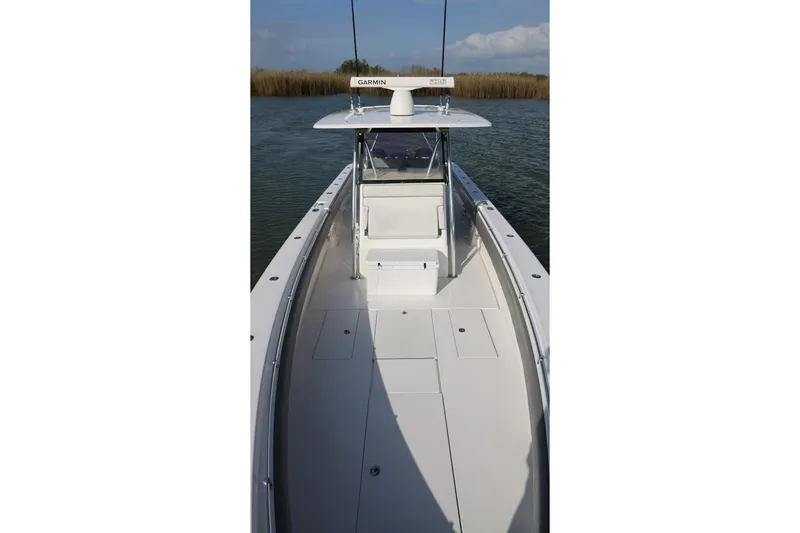 Slide: The Image of 2017 Contender 39 ST boat on water, featuring spacious deck and Garmin radar. - 11