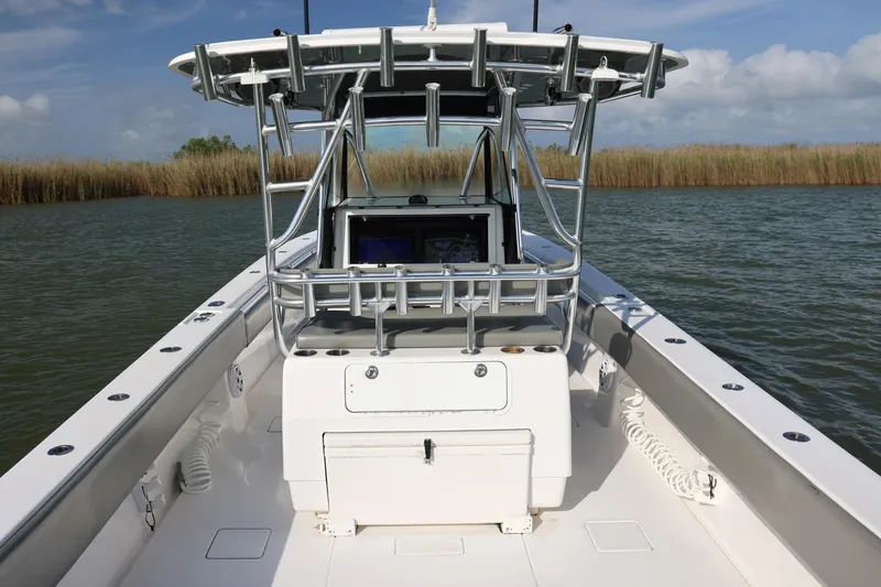 Slide: The Image of 2017 Contender 39 ST boat on water, featuring sleek design and advanced navigation equipment. - 12