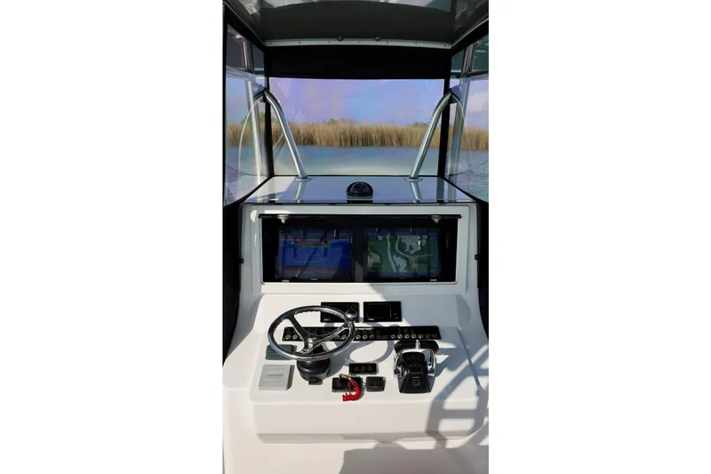 Slide: The Image of 2017 Contender 39 ST boat helm with navigation screens and steering wheel. - 13