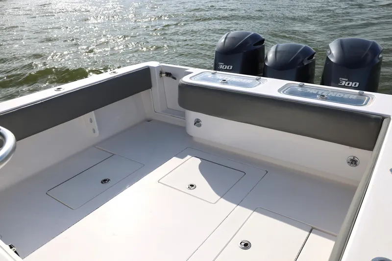 Slide: The Image of 2017 Contender 39 ST boat deck with triple Yamaha 300 engines on water. - 15