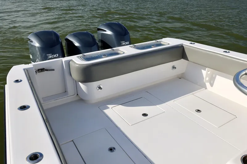 Slide: The Image of 2017 Contender 39 ST boat with triple Yamaha 300 engines on calm water. - 16