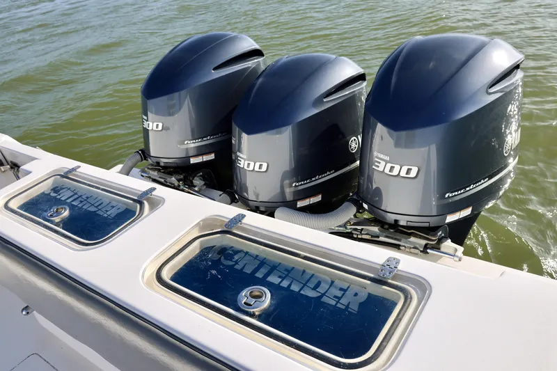 Slide: The Image of 2017 Contender 39 ST boat with triple Yamaha 300 outboard engines on water. - 17