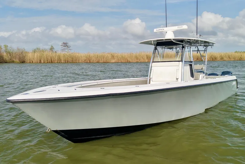 Slide: The Image of 2017 Contender 39 ST boat on calm water with clear sky background. - 2