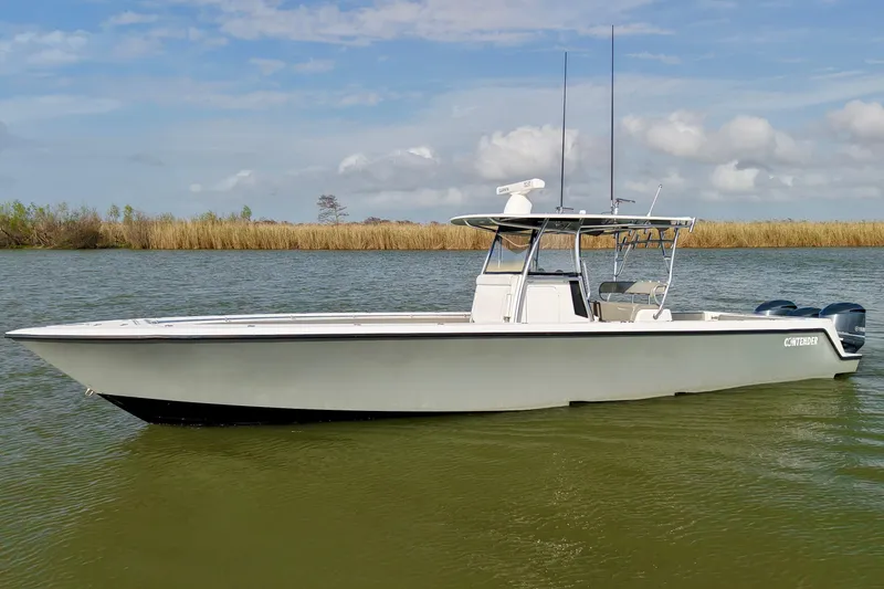Slide: The Image of 2017 Contender 39 ST boat on calm water under a partly cloudy sky. - 3