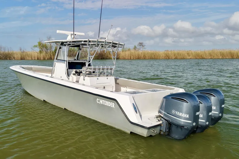 Slide: The Image of 2017 Contender 39 ST boat with triple Yamaha engines on calm water. - 4