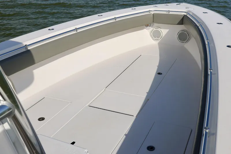 Slide: The Image of 2017 Contender 39 ST boat deck with storage compartments and speakers, on calm water. - 8