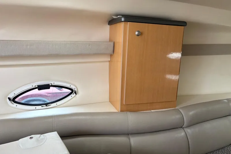 Slide: The Image of Interior of 2004 Maxum 3100 SE boat with wooden cabinet and oval window. - 12