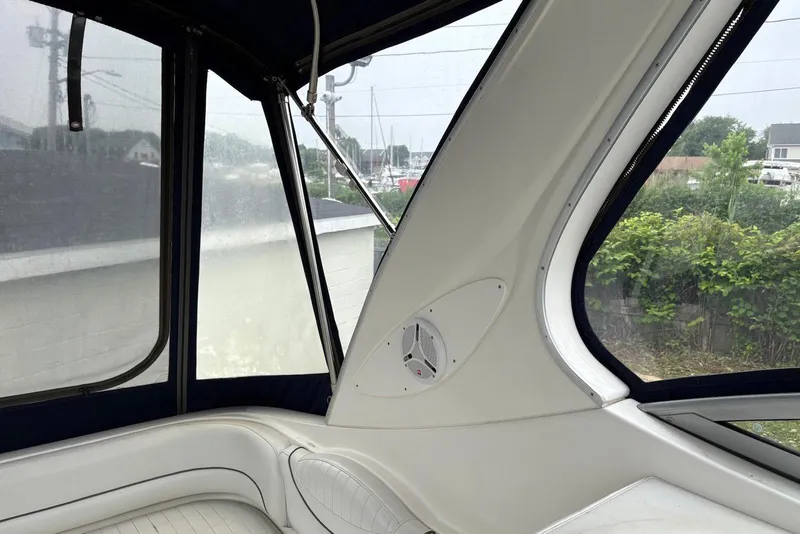 Slide: The Image of 2004 Maxum 3100 SE boat interior with white seating and window view. - 21