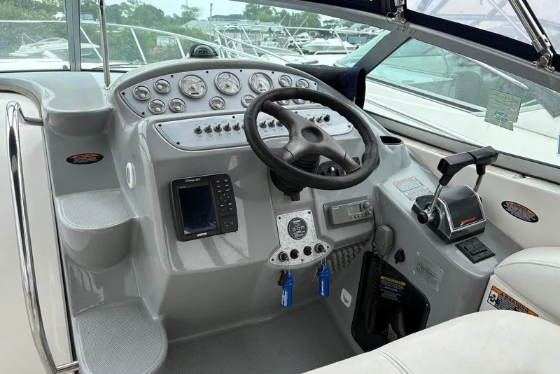 Slide: The Image of 2004 Maxum 3100 SE boat cockpit with steering wheel and control panel. - 3