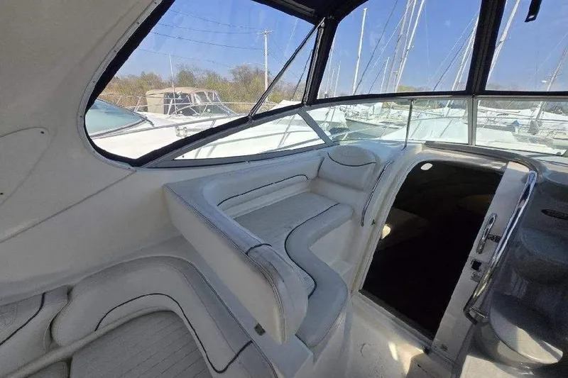 Slide: The Image of 2004 Maxum 3100 SE boat interior with white seating and sleek design. - 5