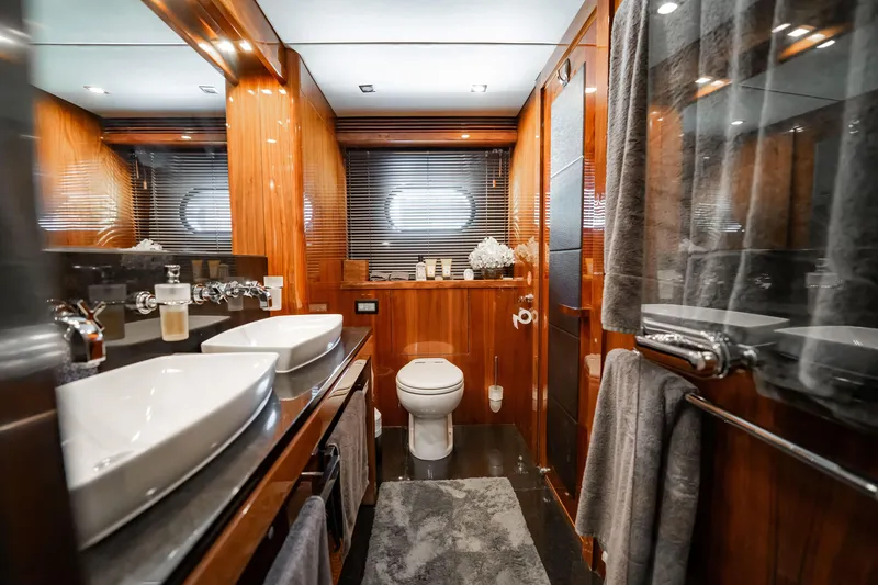 Slide: The Image of Luxurious bathroom interior on a 2010 Sunseeker 34 Metre Yacht, featuring dual sinks and elegant wood finishes. - 32