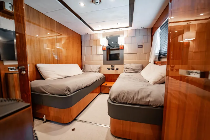 Slide: The Image of Luxurious twin cabin interior on a 2010 Sunseeker 34 Metre Yacht, featuring wood paneling. - 37