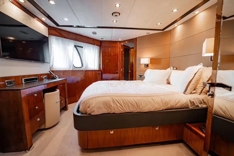 Slide: The Image of Luxurious bedroom interior on a 2010 Sunseeker 34 Metre Yacht, featuring elegant wood finishes. - 39