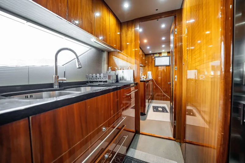 Slide: The Image of Luxurious kitchen interior of 2010 Sunseeker 34 Metre Yacht with sleek wood finishes. - 70