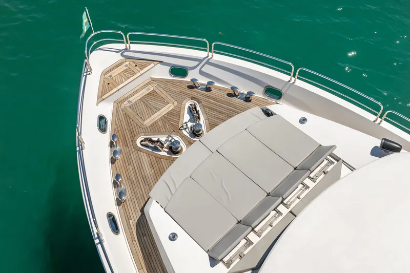 Slide: The Image of Sunseeker 34 Metre Yacht 2010, elegant deck view with sun loungers and teak flooring. - 9