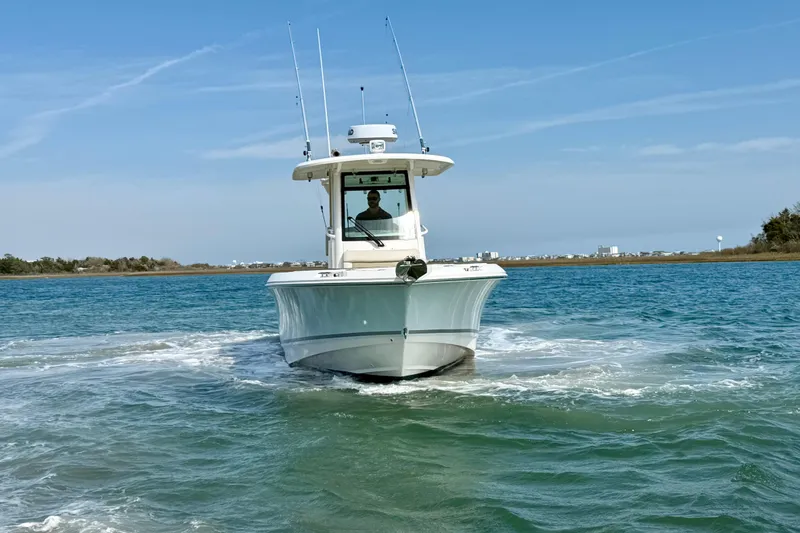Slide: The Image of 2024 Boston Whaler 250 Outrage boat navigating clear blue waters. - 12