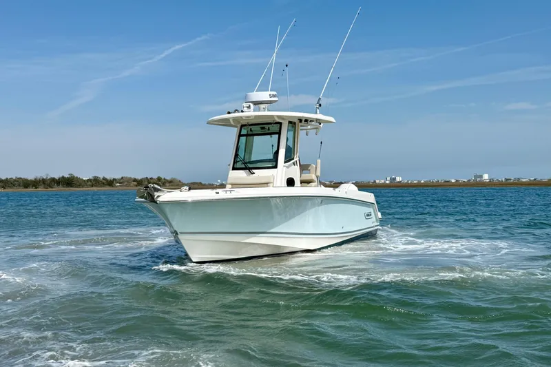 Slide: The Image of 2024 Boston Whaler 250 Outrage boat cruising on open water under clear skies. - 14