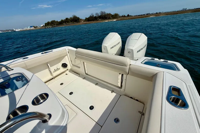 Slide: The Image of 2024 Boston Whaler 250 Outrage boat with dual Mercury engines on open water. - 19