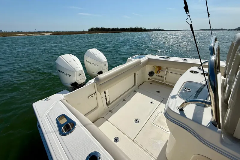 Slide: The Image of 2024 Boston Whaler 250 Outrage boat with dual Mercury engines on open water. - 21