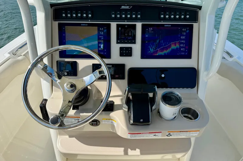 Slide: The Image of 2024 Boston Whaler 250 Outrage helm with advanced navigation displays and controls. - 28