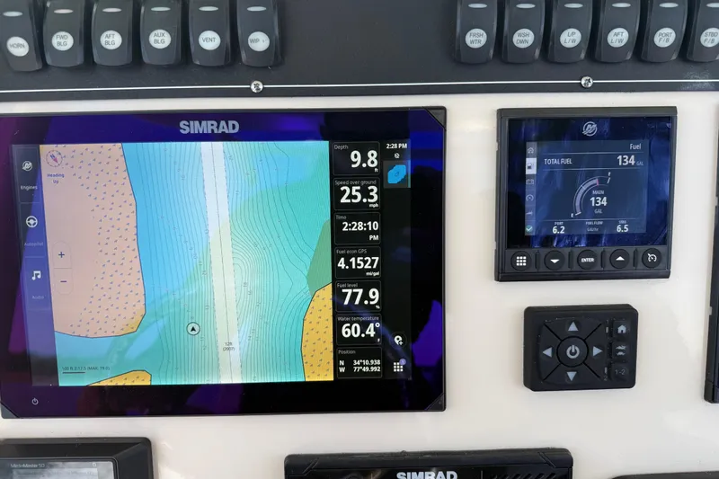 Slide: The Image of Dashboard of 2024 Boston Whaler 250 Outrage with Simrad navigation and fuel display. - 29