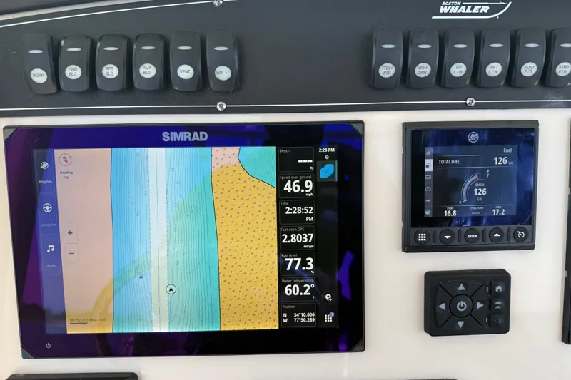 Slide: The Image of Control panel of 2024 Boston Whaler 250 Outrage with Simrad navigation display. - 30