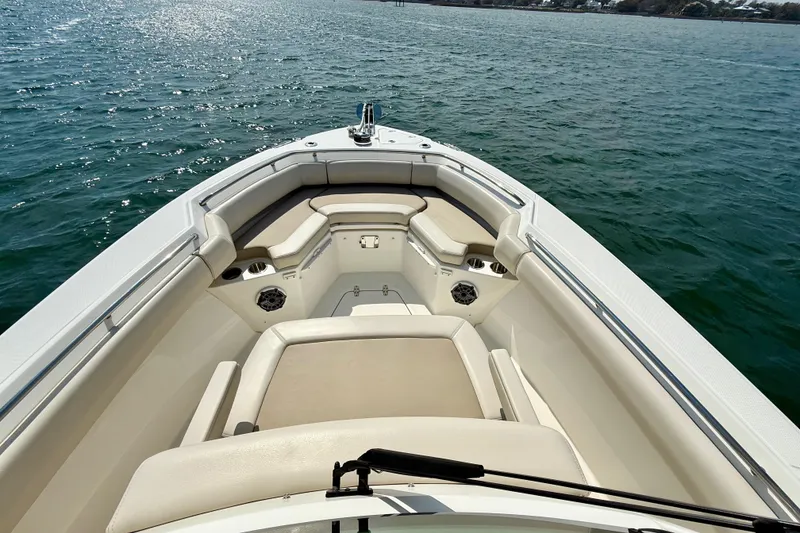 Slide: The Image of 2024 Boston Whaler 250 Outrage boat interior with cushioned seating on open water. - 33
