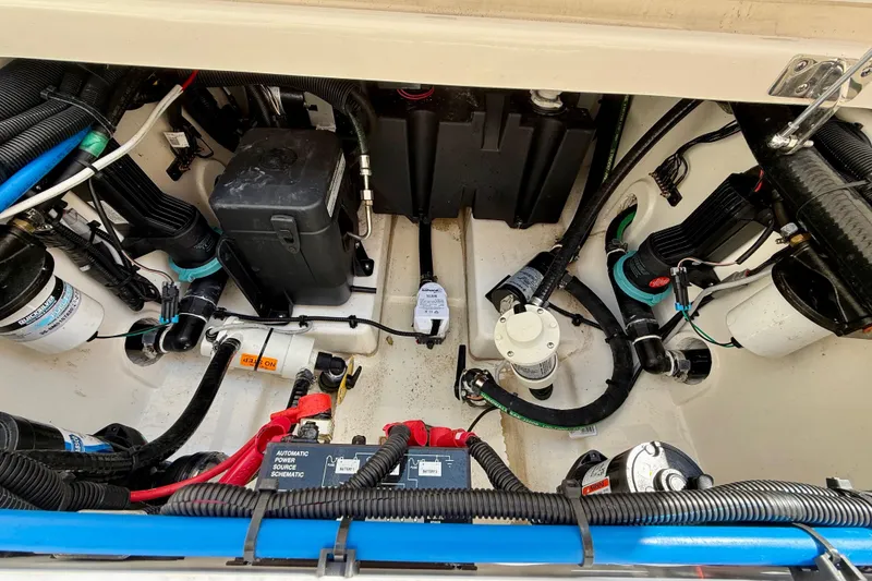Slide: The Image of 2024 Boston Whaler 250 Outrage engine compartment with wiring and components. - 39