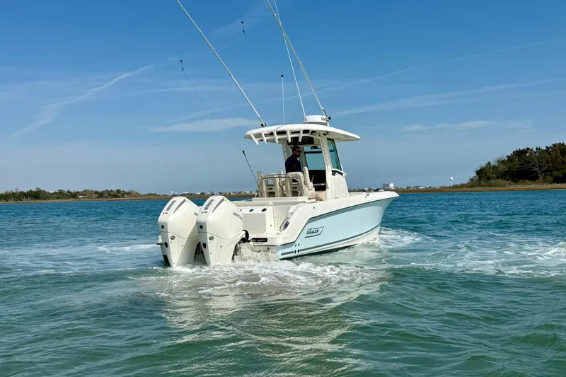 Slide: The Image of 2024 Boston Whaler 250 Outrage boat cruising on clear blue water. - 7