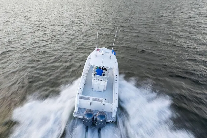 Slide: The Image of 2013 Contender 32 ST boat speeding on open water, aerial view. - 11