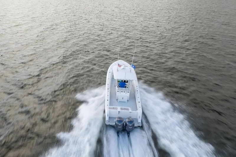 Slide: The Image of Aerial view of 2013 Contender 32 ST boat speeding on open water. - 12
