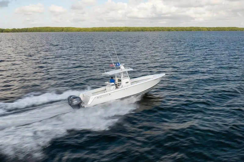 Slide: The Image of 2013 Contender 32 ST boat speeding on open water under cloudy sky. - 17