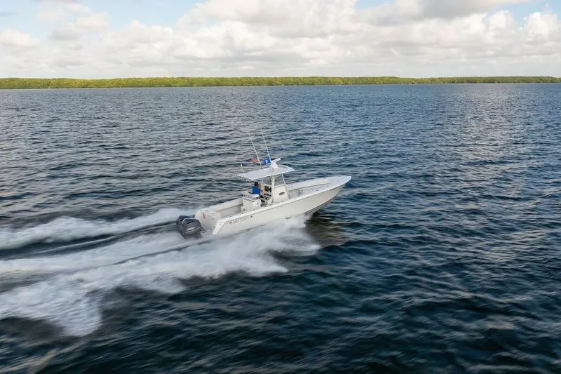 Slide: The Image of 2013 Contender 32 ST boat speeding on open water under a cloudy sky. - 18