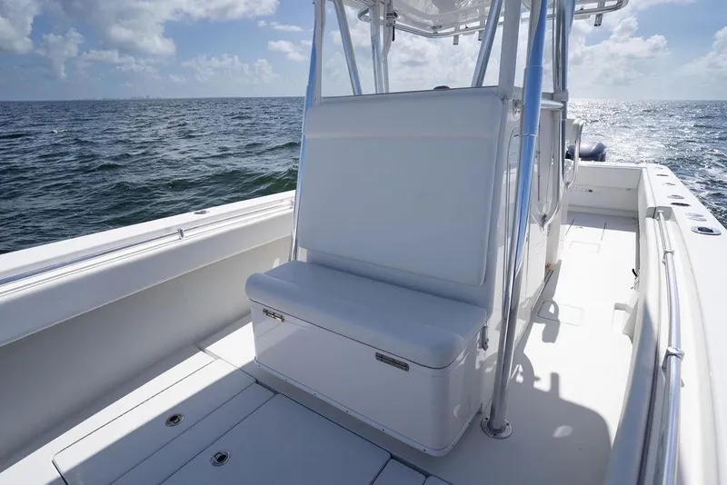 Slide: The Image of 2013 Contender 32 ST boat interior with seating, ocean view, and clear skies. - 25