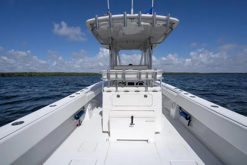 Slide: The Image of 2013 Contender 32 ST boat on open water under clear blue sky. - 28