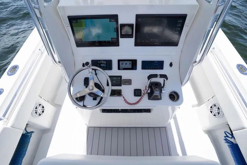 Slide: The Image of 2013 Contender 32 ST boat console with steering wheel and navigation screens. - 29