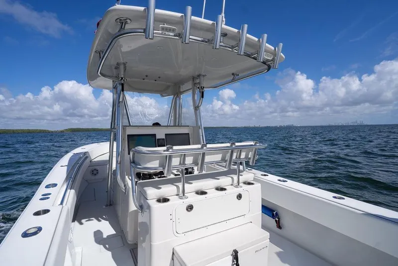 Slide: The Image of 2013 Contender 32 ST boat on open water under a clear blue sky. - 30