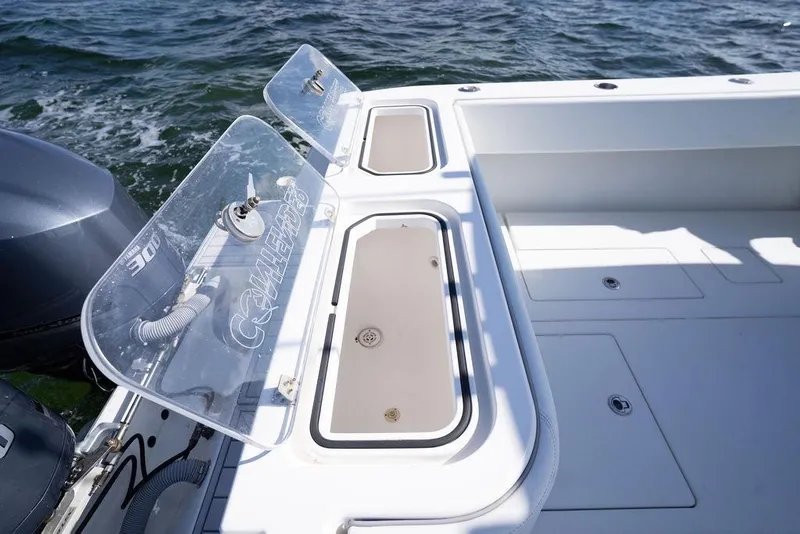 Slide: The Image of 2013 Contender 32 ST boat deck with storage compartments and dual outboard engines. - 31