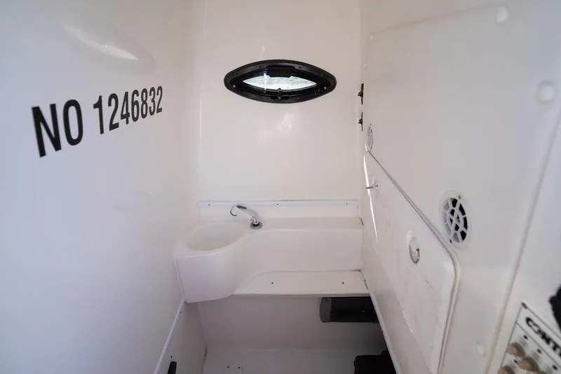 Slide: The Image of Interior of 2013 Contender 32 ST boat with sink and porthole. - 35