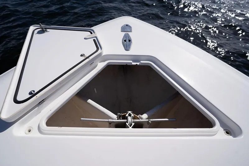 Slide: The Image of Open anchor compartment on 2013 Contender 32 ST boat, with ocean in background. - 36
