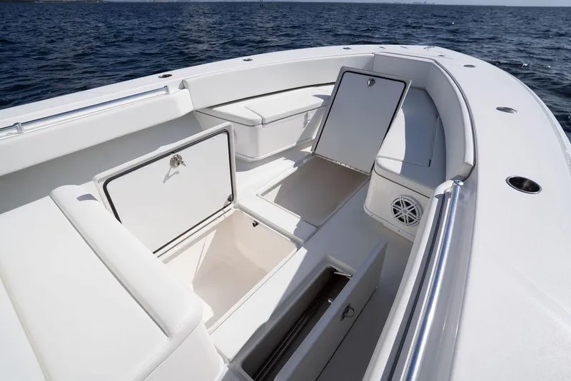 Slide: The Image of 2013 Contender 32 ST boat with open storage compartments on a sunny day at sea. - 37