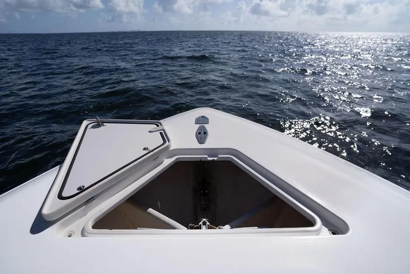 Slide: The Image of 2013 Contender 32 ST boat on open sea with anchor hatch open. - 38