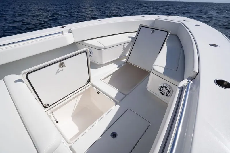 Slide: The Image of 2013 Contender 32 ST boat with open storage compartments on deck, ocean in background. - 39