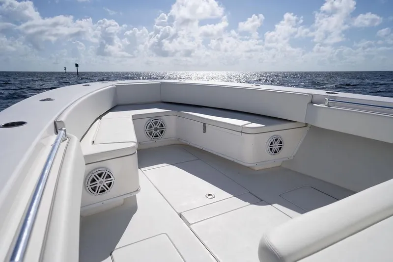 Slide: The Image of 2013 Contender 32 ST boat interior with seating, ocean view, and clear sky. - 42