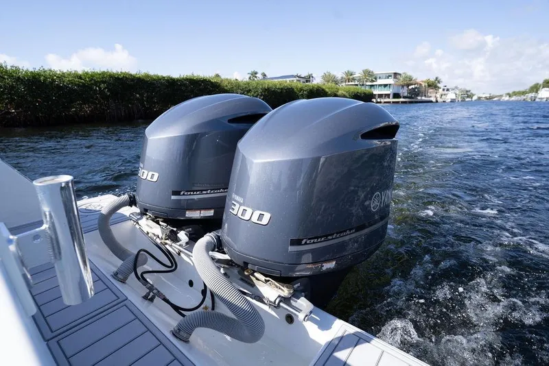 Slide: The Image of Twin Yamaha 300 outboard engines on a 2013 Contender 32 ST boat cruising on water. - 43