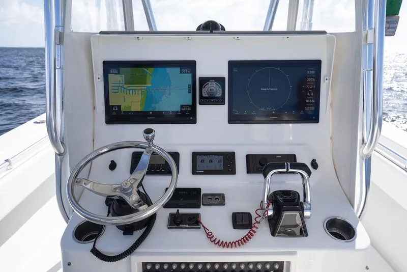 Slide: The Image of Control panel of 2013 Contender 32 ST boat with navigation screens and steering wheel. - 45