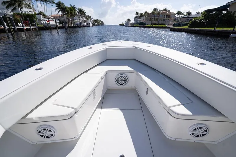 Slide: The Image of 2013 Contender 32 ST boat interior with white seating, cruising on a scenic waterway. - 46