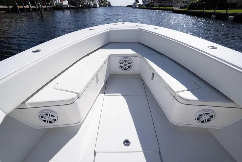 Slide: The Image of 2013 Contender 32 ST boat interior with white seating and speakers on a sunny day. - 47