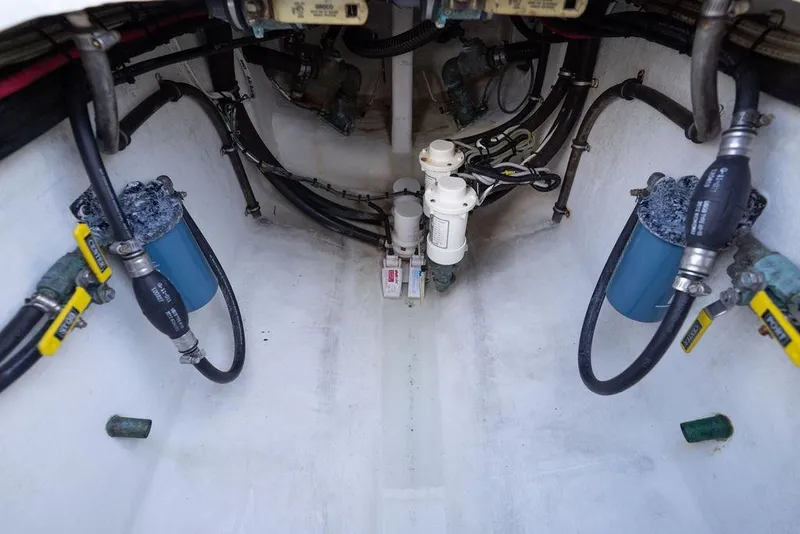 Slide: The Image of 2013 Contender 32 ST boat engine compartment with hoses and filters. - 48