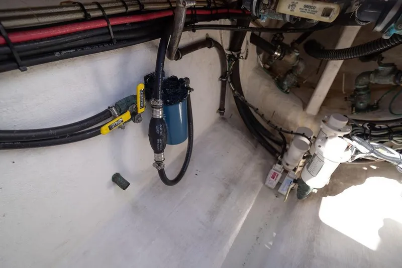 Slide: The Image of 2013 Contender 32 ST boat engine compartment with hoses and filters. - 49